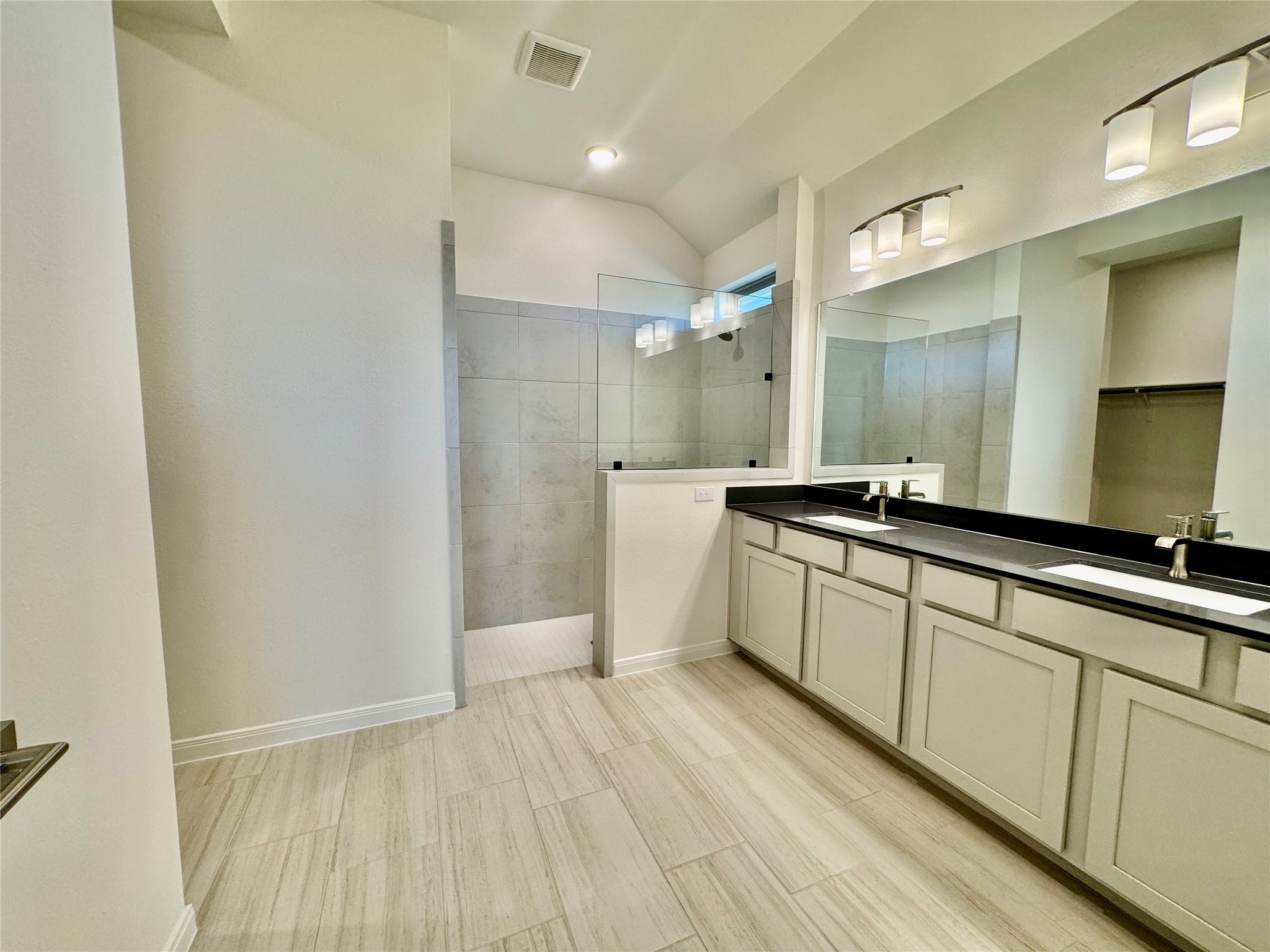 8923 Moose Trail Manvel, TX 77578 - Photo 13 of 20 a large bathroom with a double vanity sink and mirror