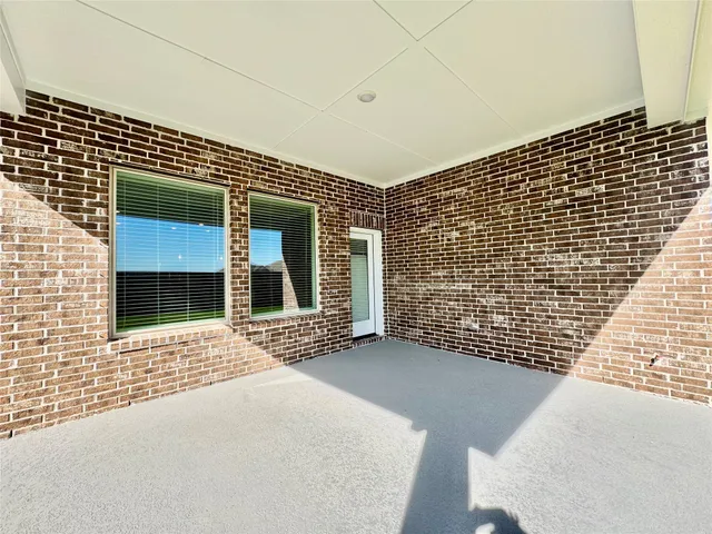 a view of a brick house with an outdoor space