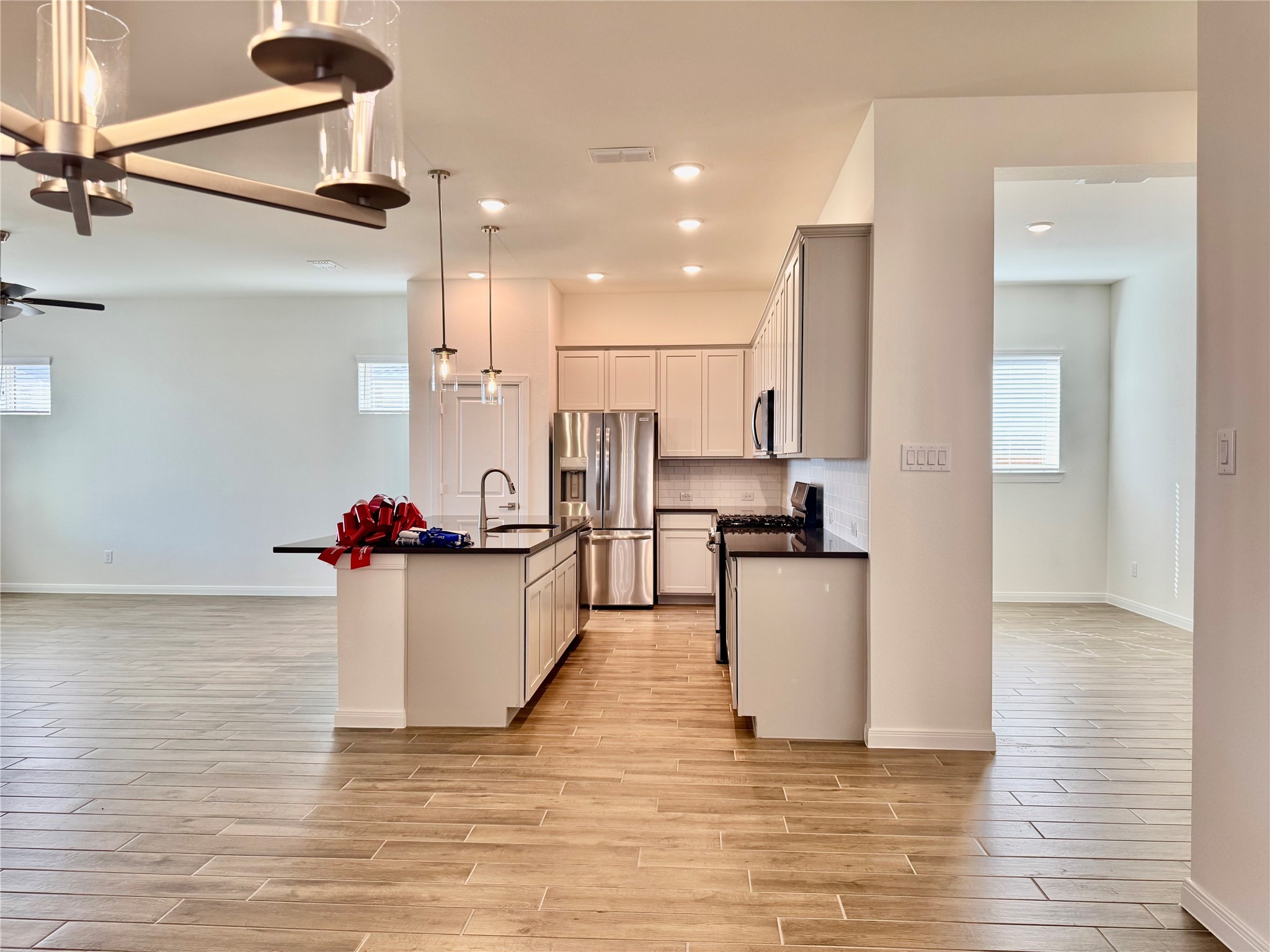 8923 Moose Trail Manvel, TX 77578 - Photo 2 of 20 a kitchen with a sink cabinets and wooden floor
