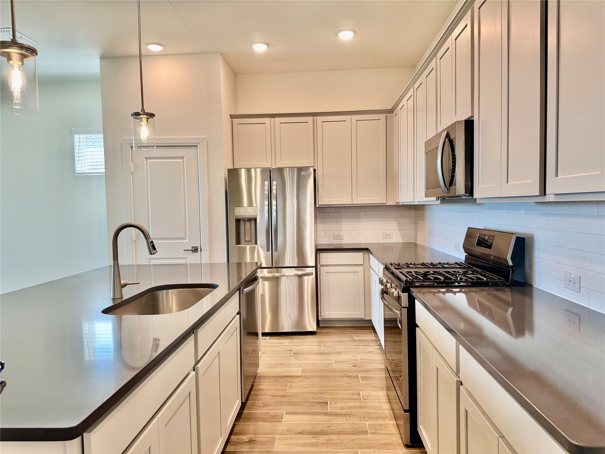 8923 Moose Trail Manvel, TX 77578 - Photo 3 of 20 a kitchen with stainless steel appliances granite countertop a sink stove and refrigerator