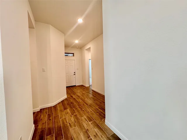 a view of hallway with wooden floor