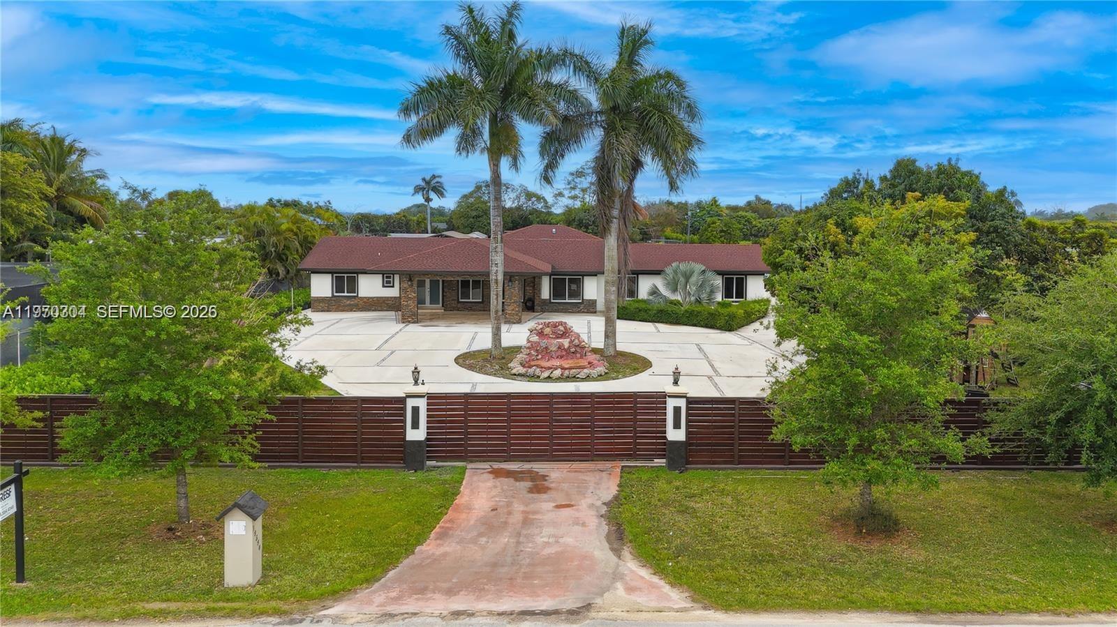19390 Southwest 312th Street Homestead, FL 33030 - Photo 2 of 44 a swimming pool with outdoor seating yard and barbeque oven