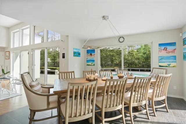 a view of a dining room with furniture large windows and wooden floor
