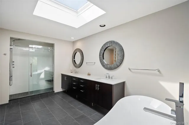 a bathroom with a toilet a sink and a mirror