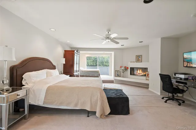 a bedroom with a bed a table and a fireplace