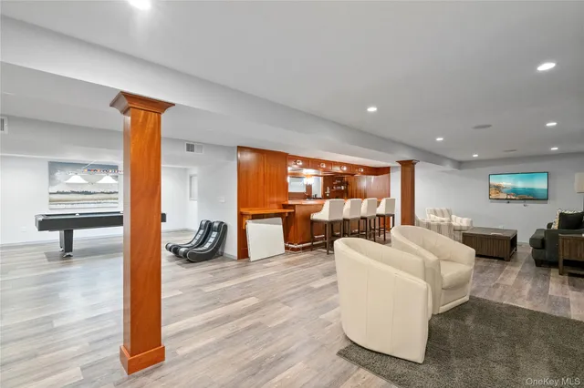 a living room with fireplace furniture and a wooden floor