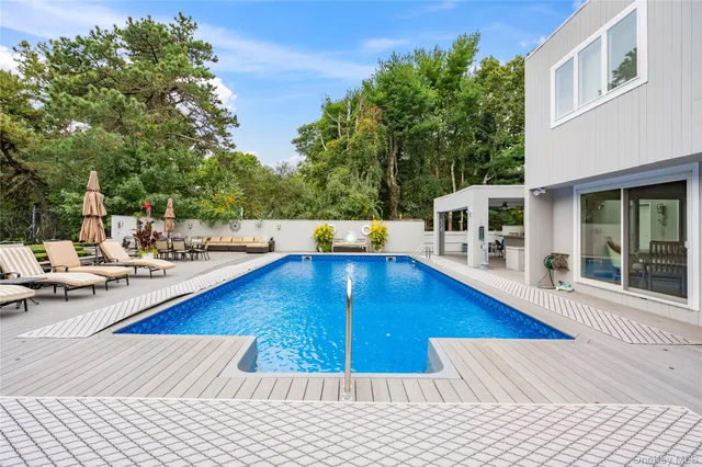 a view of a swimming pool with a lounge chair