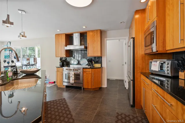 a kitchen with sink refrigerator and cabinets
