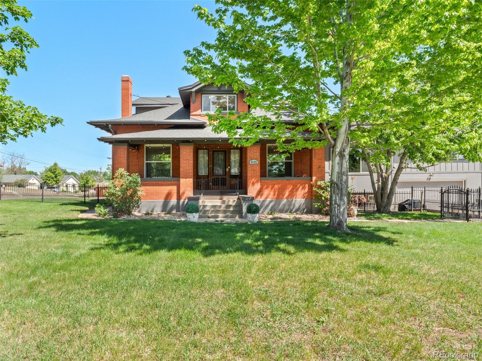 6595 West 46th Place Wheat Ridge, CO 80033 - Photo 2 of 48 a front view of a house with garden