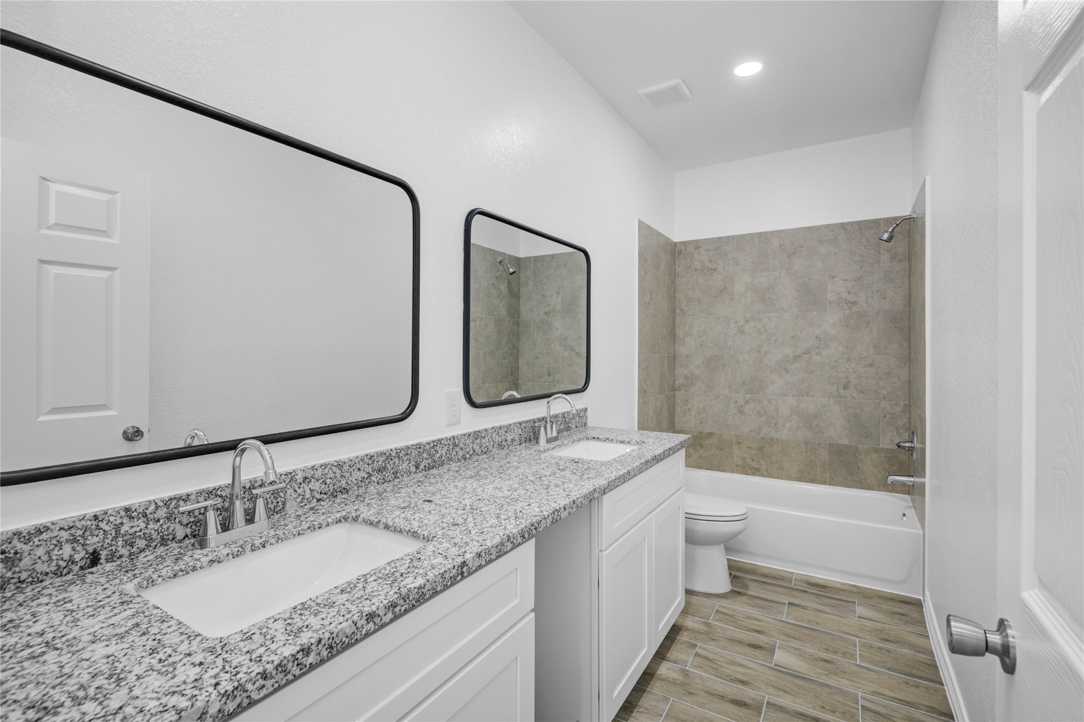 9932 Fillmore Street Houston, TX 77029 - Photo 14 of 27 a bathroom with a granite countertop sink mirror and a bathtub