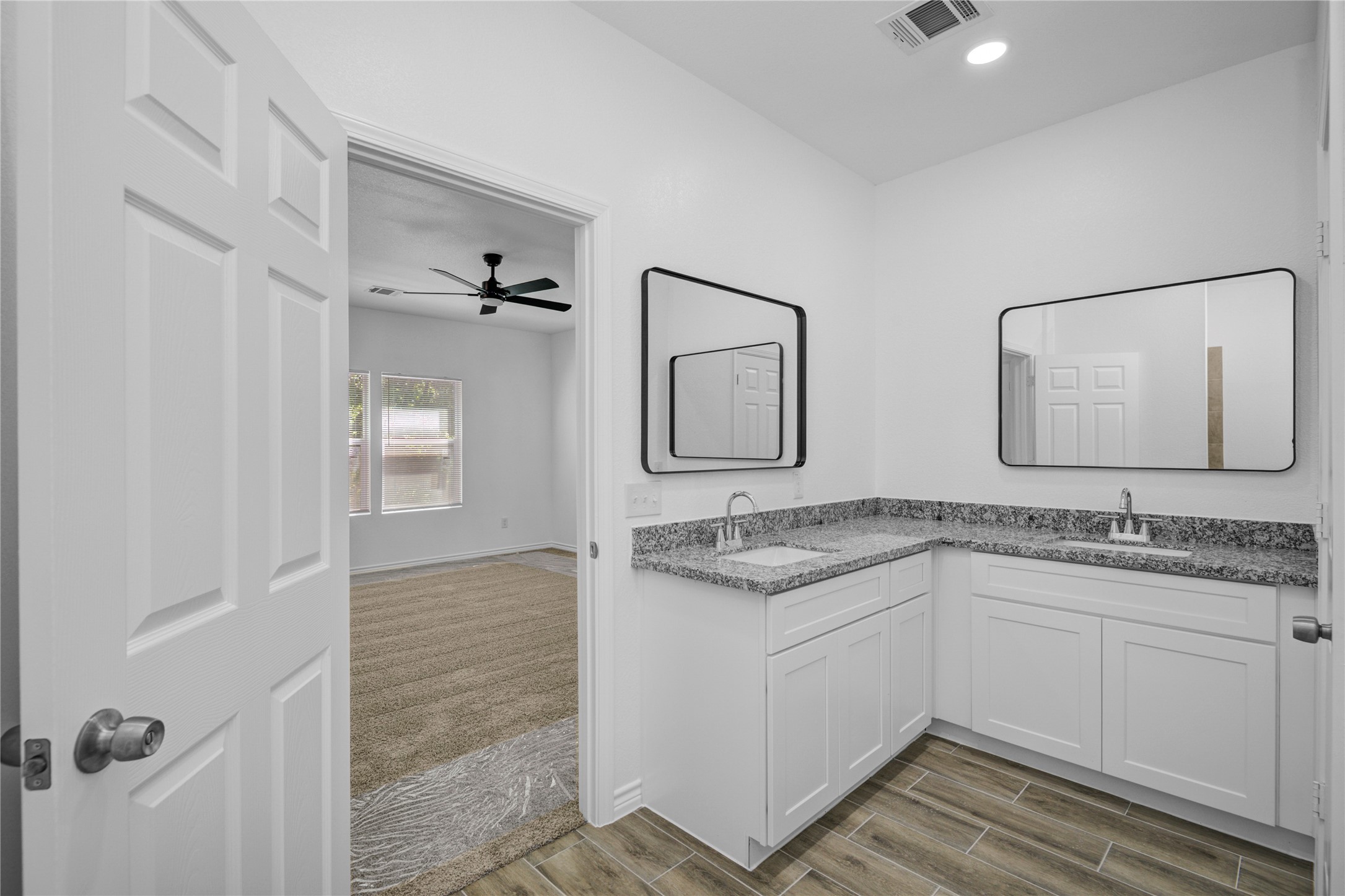 9932 Fillmore Street Houston, TX 77029 - Photo 22 of 27 a bathroom with a granite countertop sink a mirror and vanity