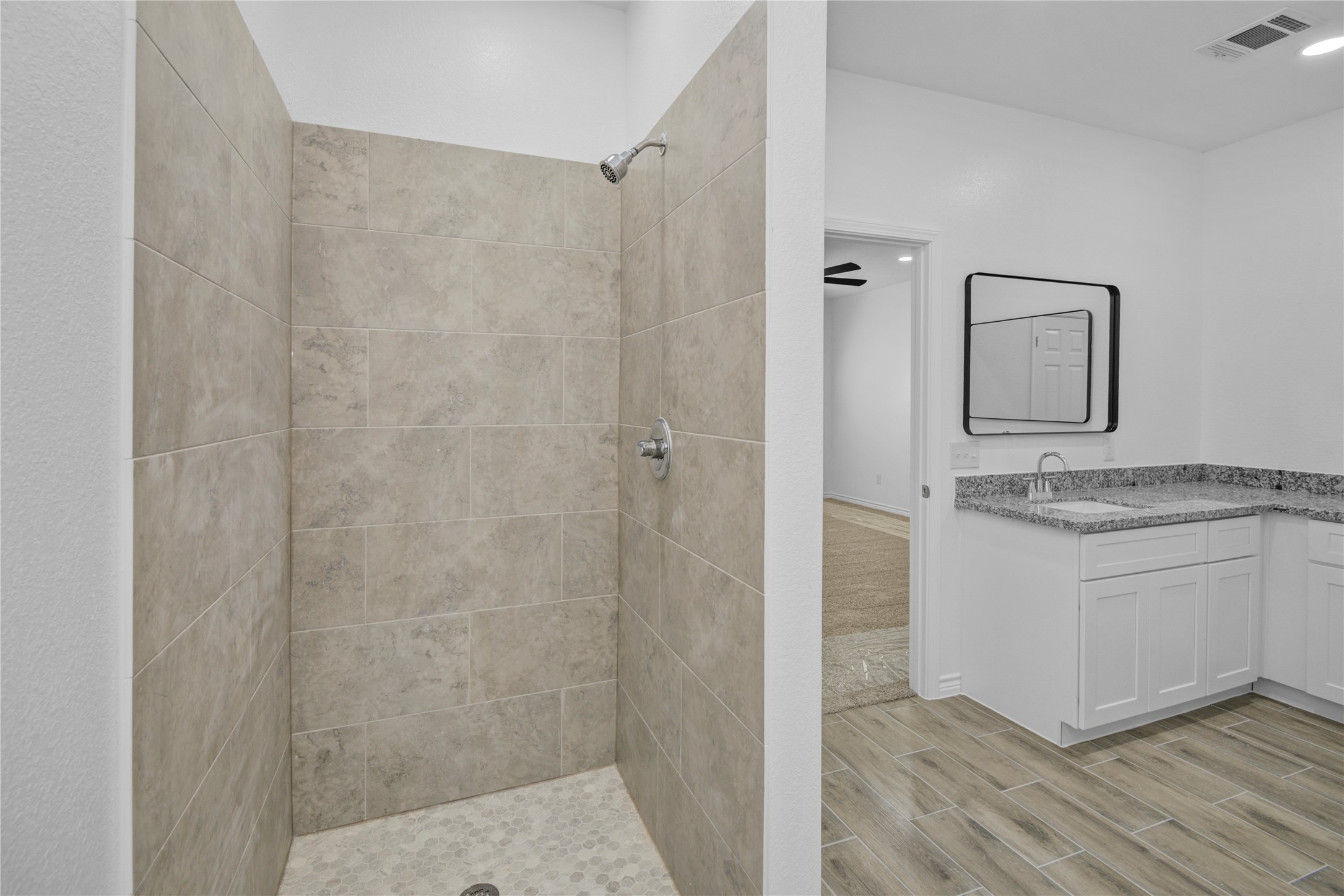 9932 Fillmore Street Houston, TX 77029 - Photo 24 of 27 a bathroom with a granite countertop sink toilet and shower
