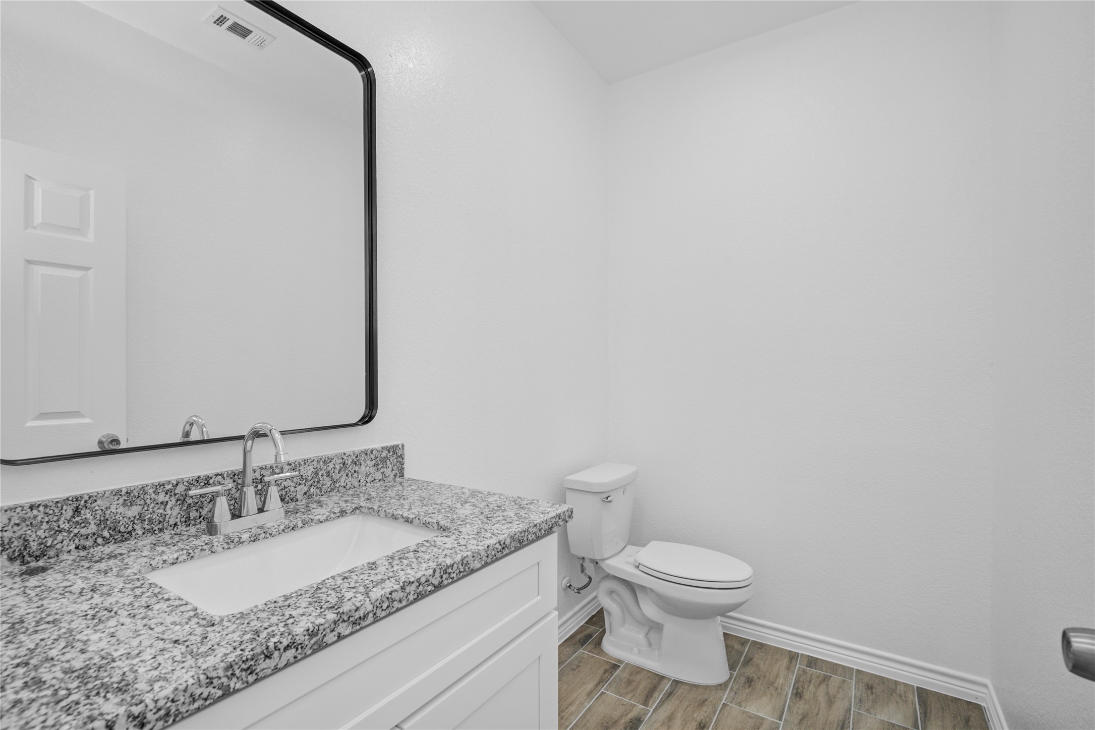 9932 Fillmore Street Houston, TX 77029 - Photo 6 of 27 a bathroom with a granite countertop toilet and a sink