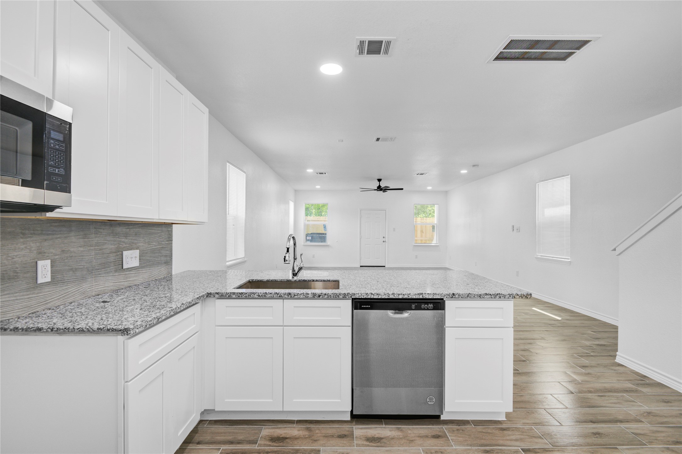 9932 Fillmore Street Houston, TX 77029 - Photo 9 of 27 a kitchen with kitchen island granite countertop a sink cabinets and stainless steel appliances