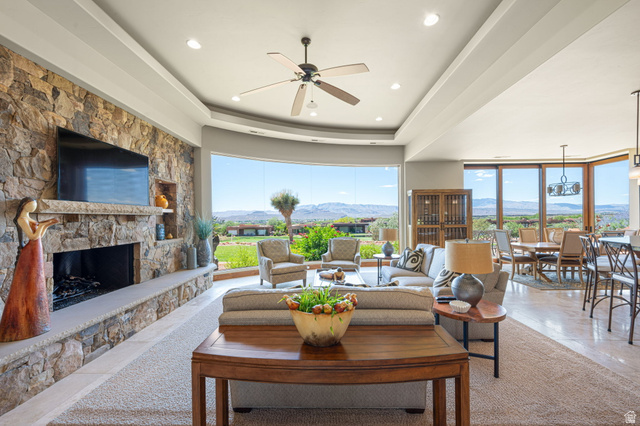 2331 West Entrada Trail, Unit 61 St. George, UT 84770 - Photo 9 of 69 Spacious interior featuring a stone-clad fireplace, large picture windows, recessed lighting, a ceiling fan, and hardwood flooring in the dining area