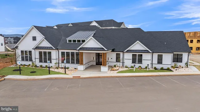 a front view of house with outdoor seating and yard