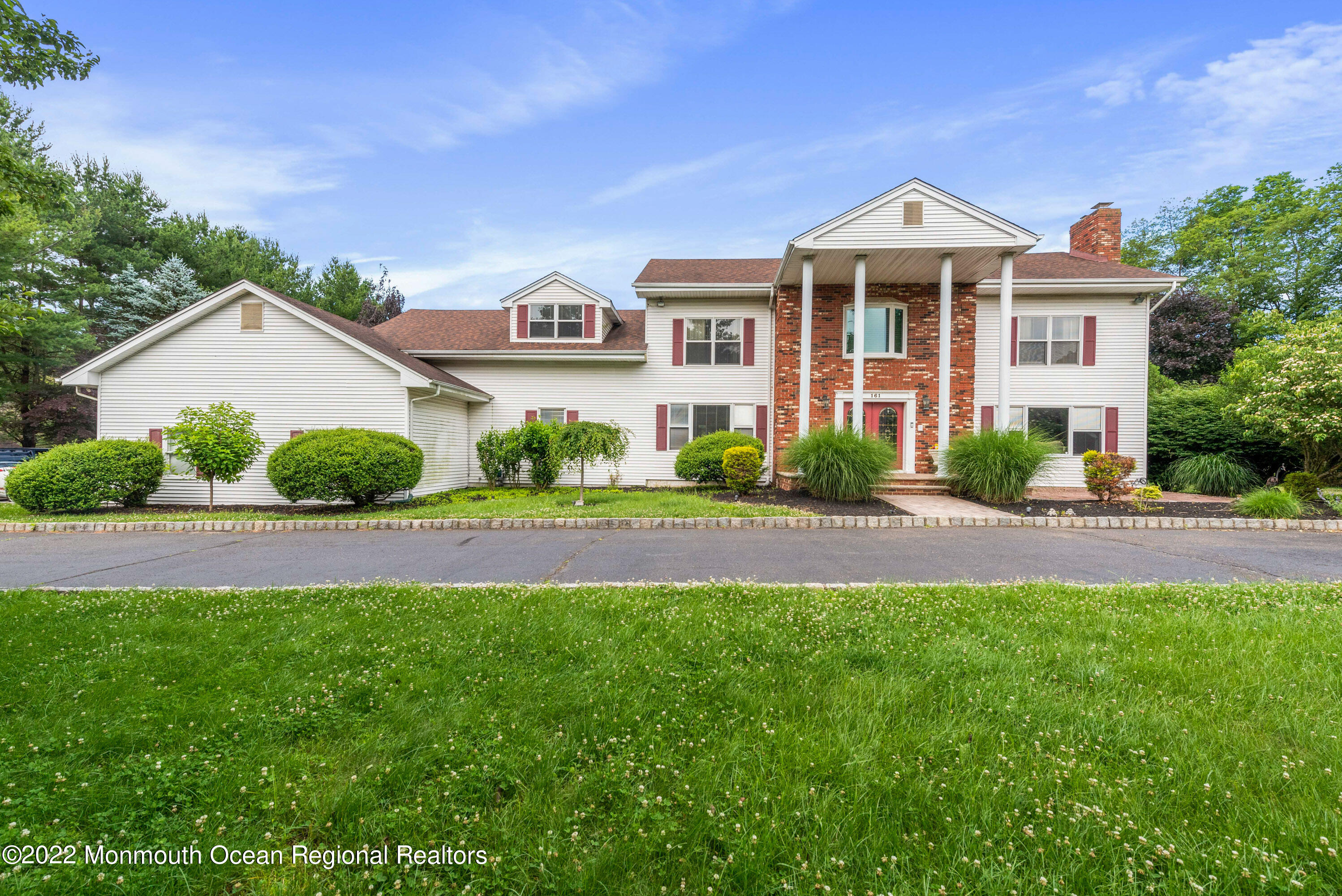 161 Thompson Grove Road Manalapan, NJ 07726 - Photo 1 of 27 a front view of a house with a yard