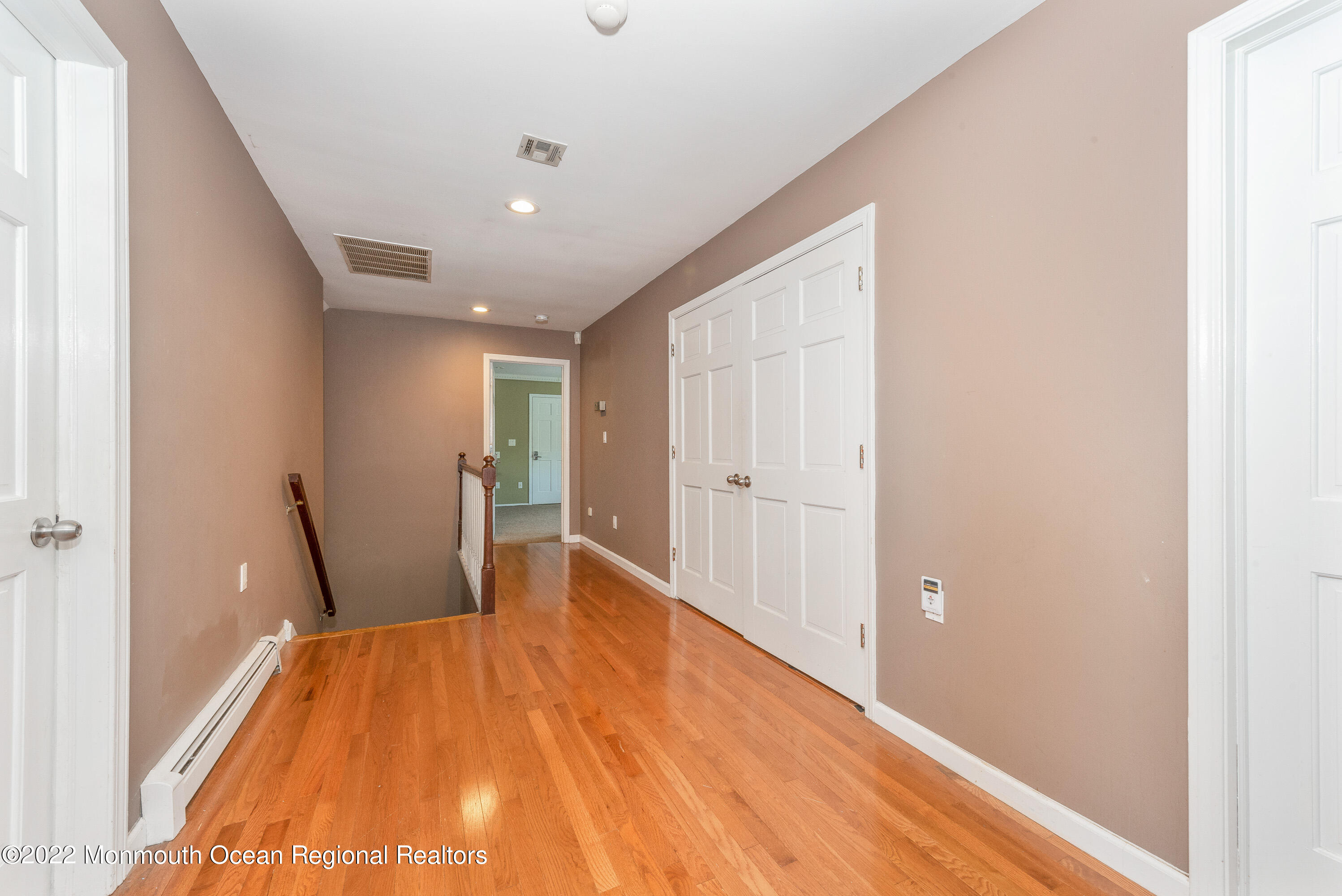 161 Thompson Grove Road Manalapan, NJ 07726 - Photo 12 of 27 a bed room with a bed and wooden floor