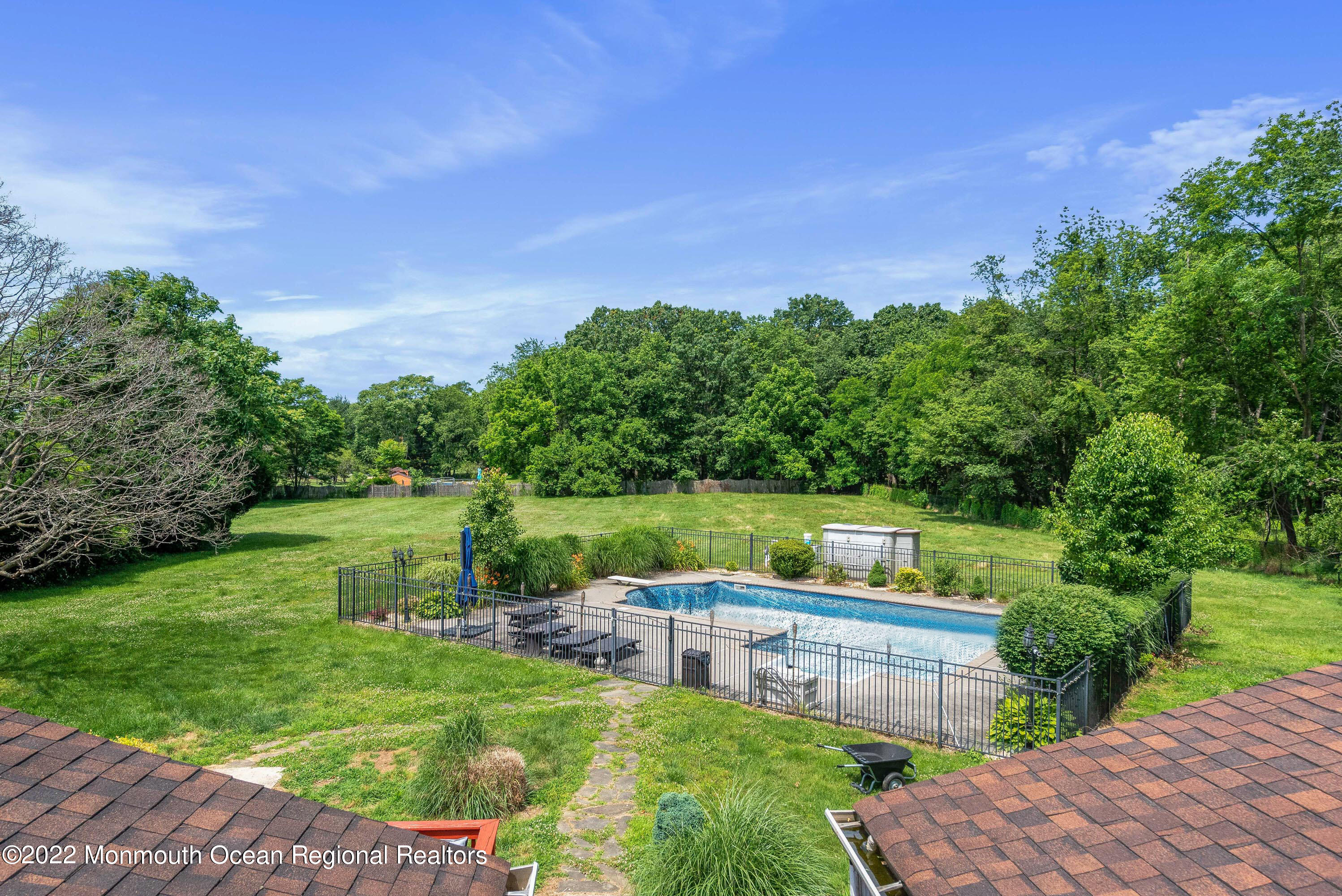 161 Thompson Grove Road Manalapan, NJ 07726 - Photo 25 of 27 a view of a lake with a big yard