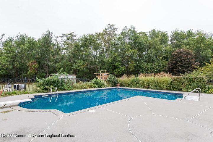 161 Thompson Grove Road Manalapan, NJ 07726 - Photo 26 of 27 a view of a swimming pool with a yard
