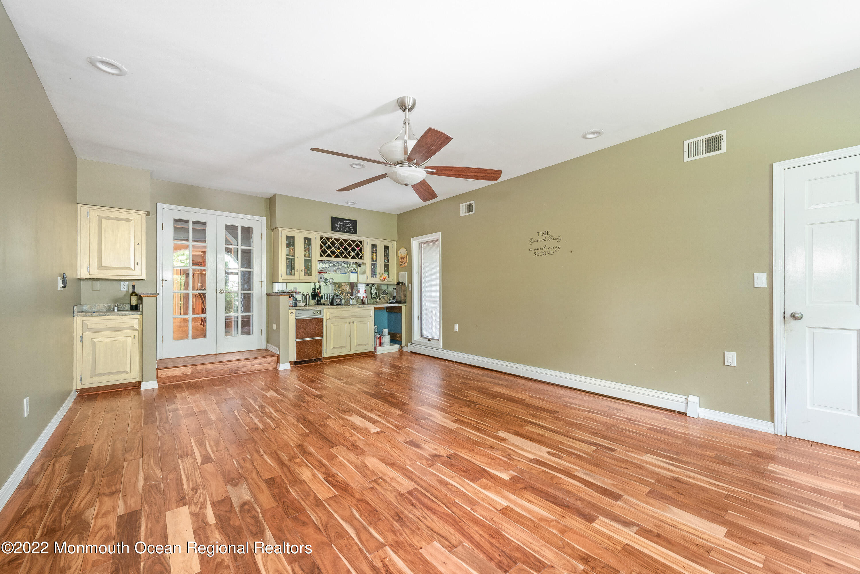 161 Thompson Grove Road Manalapan, NJ 07726 - Photo 6 of 27 a view of a big room with wooden floor and windows