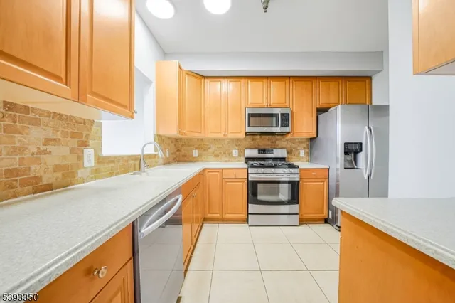 a kitchen with stainless steel appliances a stove cabinets and a sink