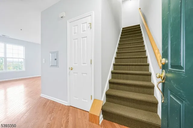 a view of an entryway with wooden floor and stairs