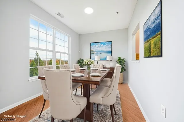 a view of a dining room with furniture and window