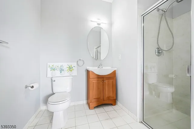 a bathroom with a toilet a sink and shower