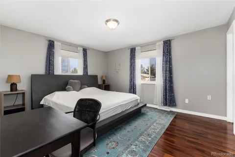 a view of a livingroom with wooden floor and a white door