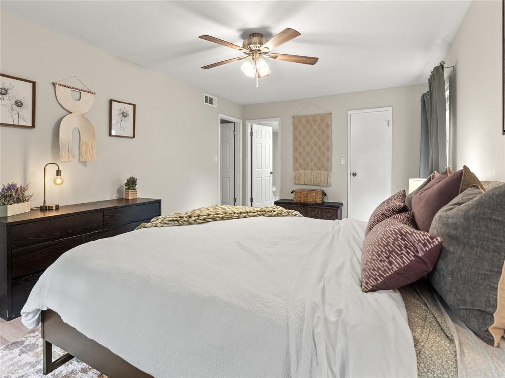 6851 Roswell Road, Unit H26 Atlanta, GA 30328 - Photo 15 of 49 a bedroom with a bed and a chandelier