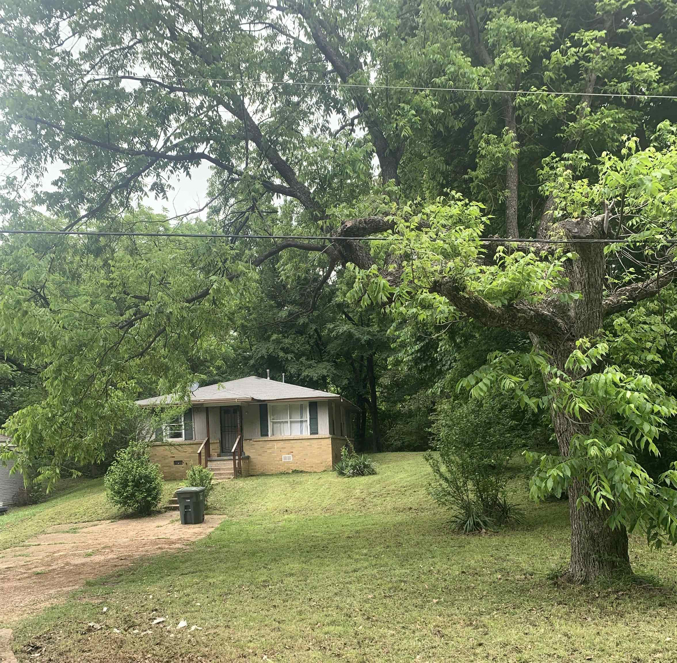 a backyard of a house with a yard and outdoor seating