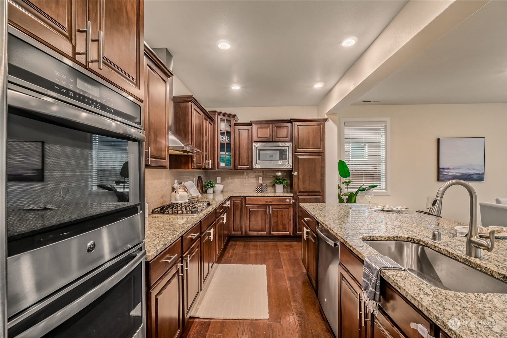 17514 39th Avenue Southeast Bothell, WA 98012 - Photo 12 of 40 a kitchen with stainless steel appliances granite countertop sink stove and refrigerator