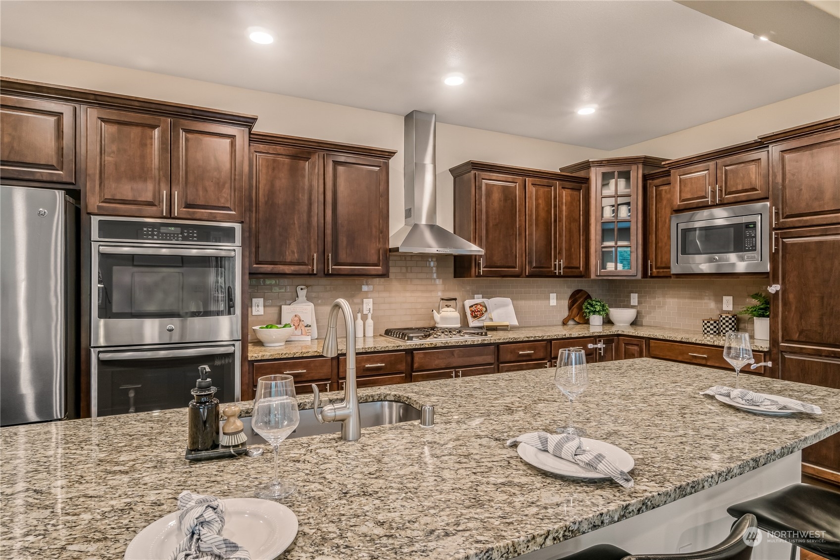 17514 39th Avenue Southeast Bothell, WA 98012 - Photo 13 of 40 a kitchen with stainless steel appliances granite countertop a sink refrigerator and cabinets