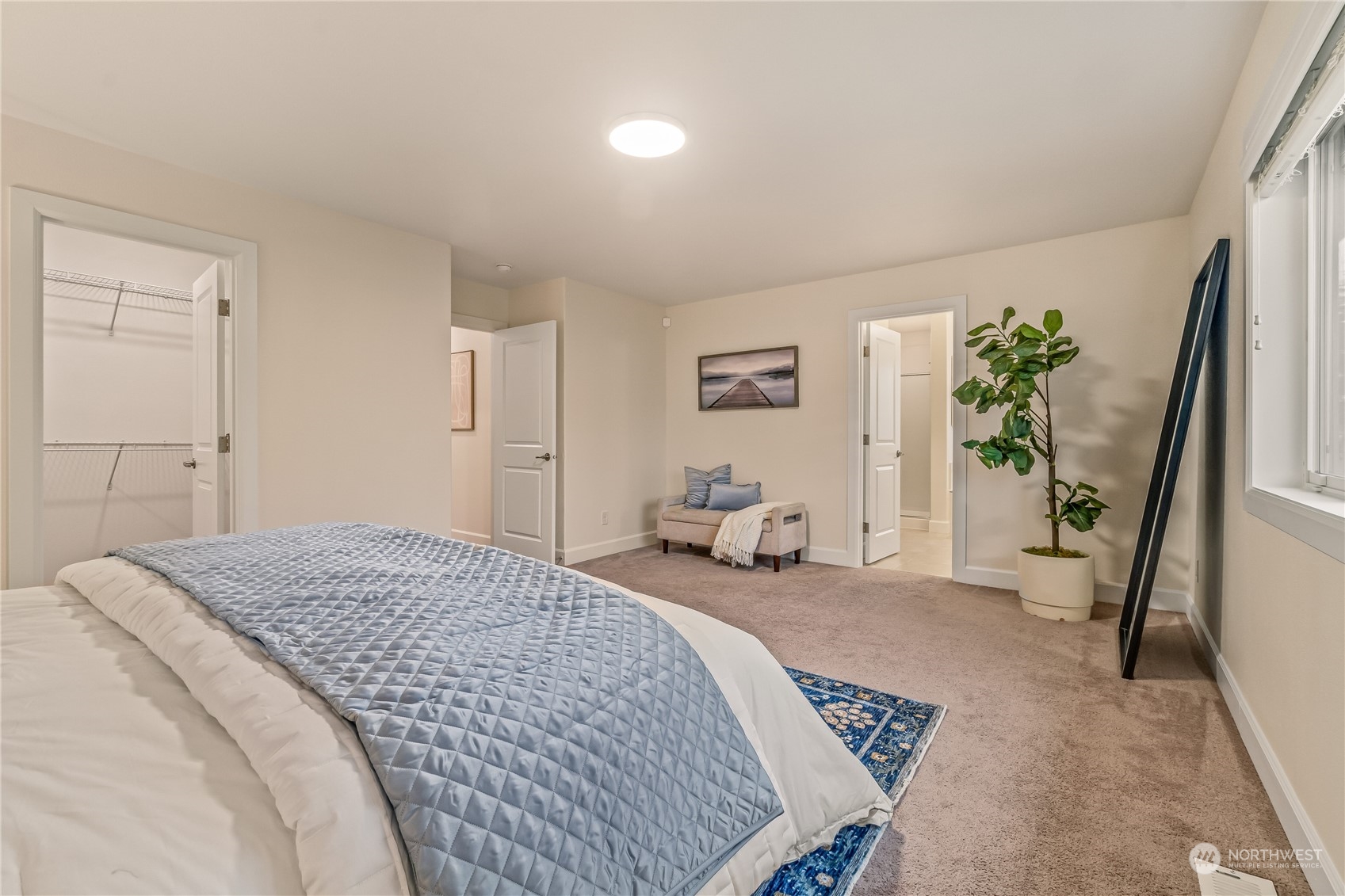 17514 39th Avenue Southeast Bothell, WA 98012 - Photo 19 of 40 a spacious bedroom with a bed a couch and a potted plant