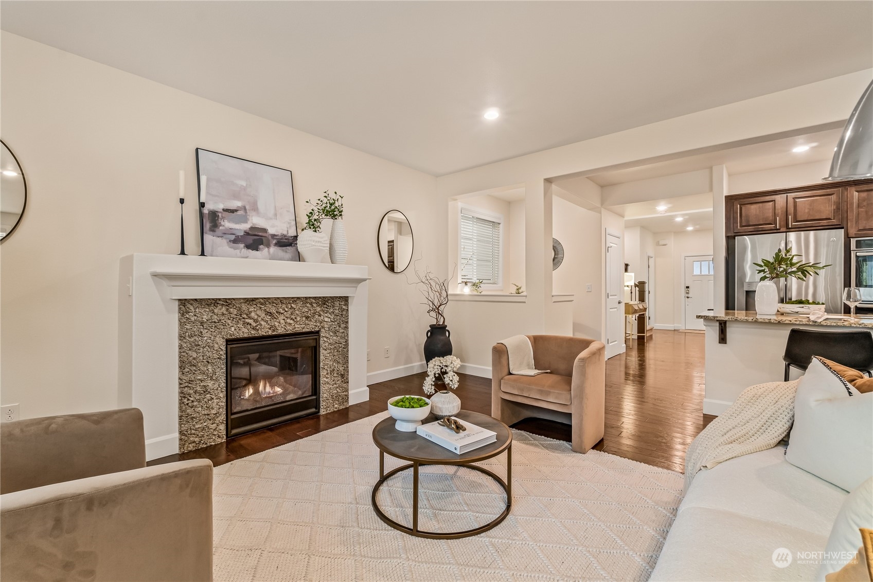 17514 39th Avenue Southeast Bothell, WA 98012 - Photo 6 of 40 a living room with furniture a fireplace and a large mirror