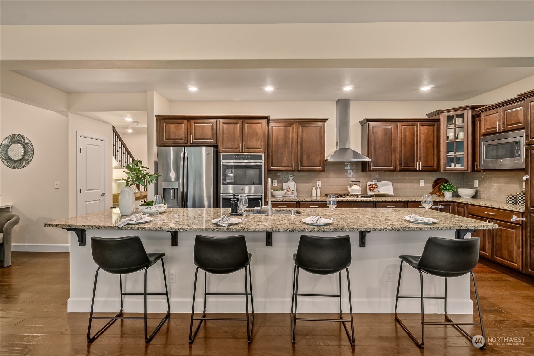 17514 39th Avenue Southeast Bothell, WA 98012 - Photo 10 of 40 a kitchen with lots of counter space chairs and refrigerator