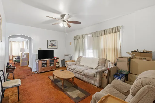 a living room with furniture a large window and a fireplace