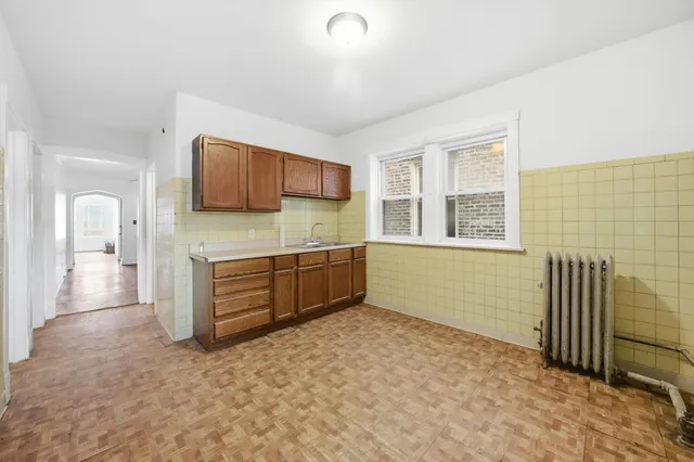 a kitchen with stainless steel appliances a refrigerator and a stove top oven