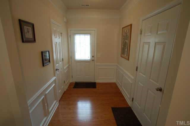 7038 Racine Way Raleigh, NC 27615 - Photo 3 of 12 Entry foyer has hardwoods, wainscoting and two piece crown Other