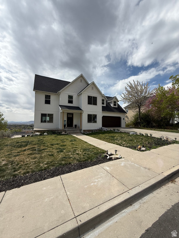 965 North 800 East Springville, UT 84663 - Photo 6 of 46 Modern farmhouse style home with a front yard, concrete driveway, a porch, board and batten siding, and roof with shingles