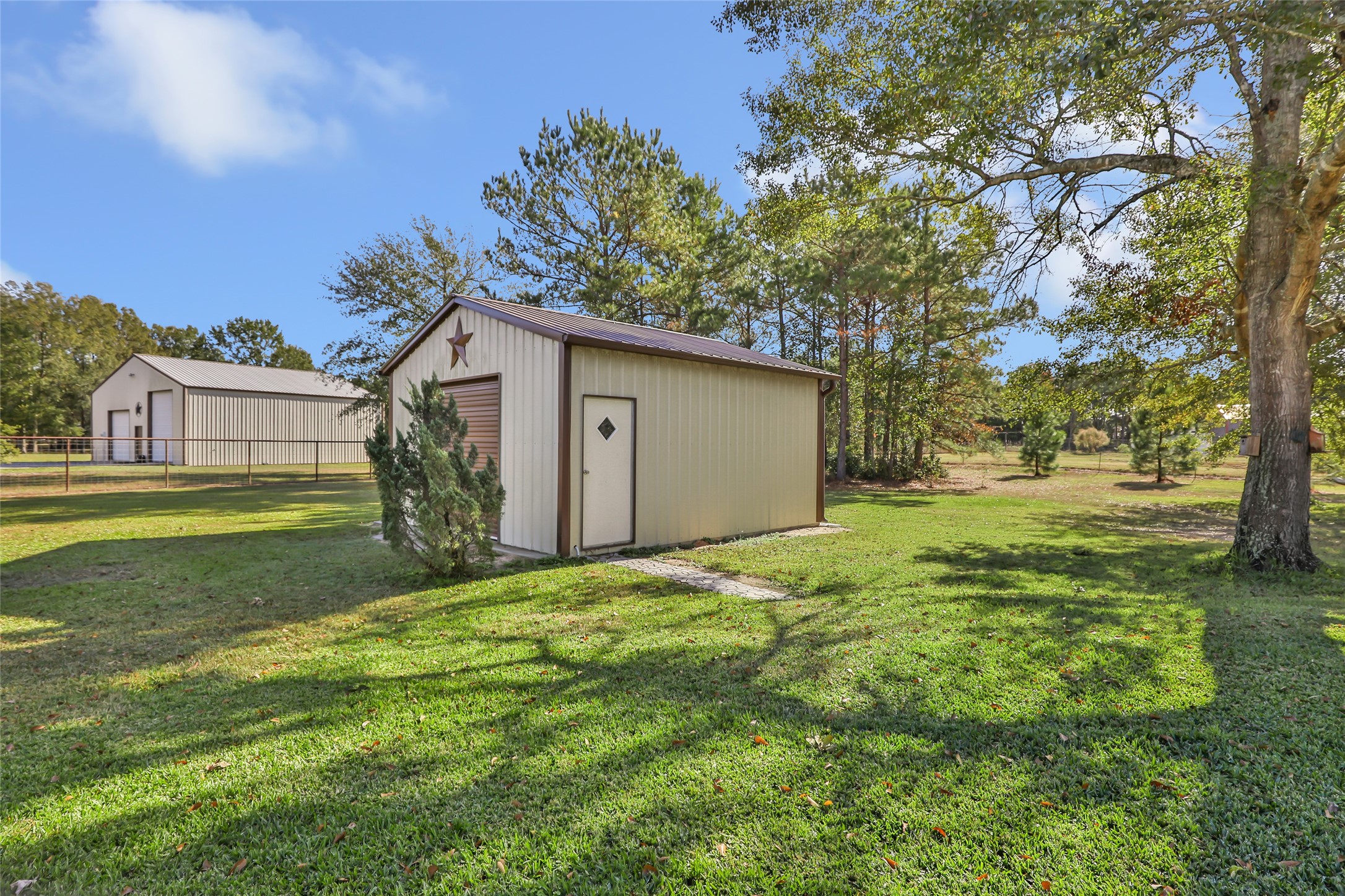 9006 Water Buck Lane Conroe, TX 77303 - Photo 16 of 48 a yellow house with garden in front of it