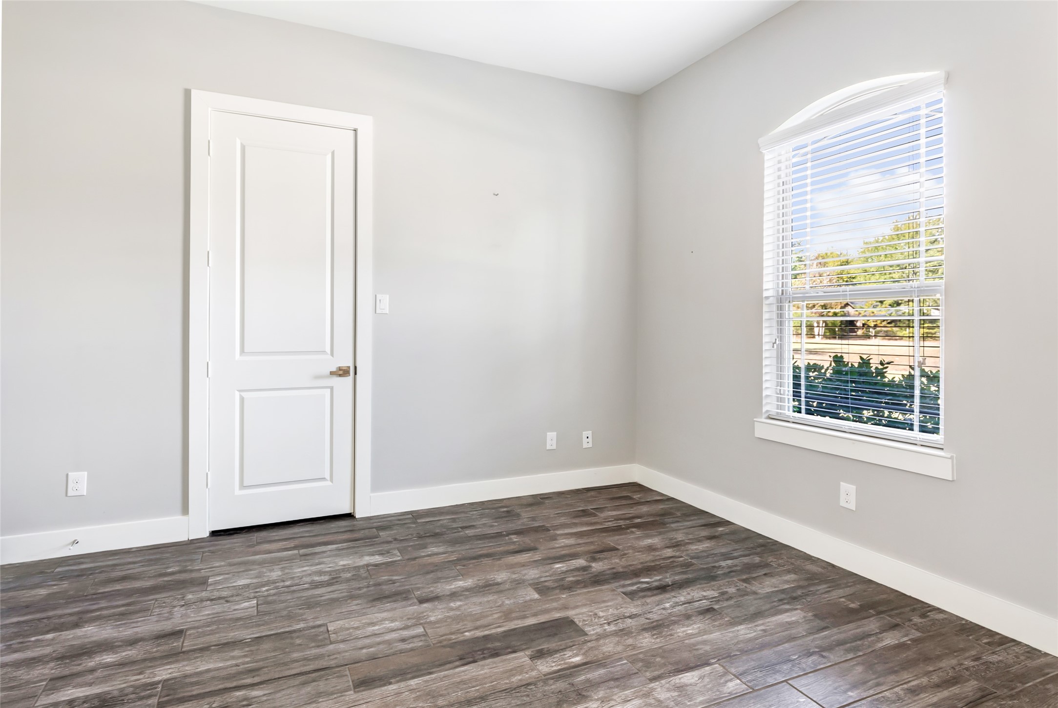 9006 Water Buck Lane Conroe, TX 77303 - Photo 24 of 48 an empty room with wooden floor and windows