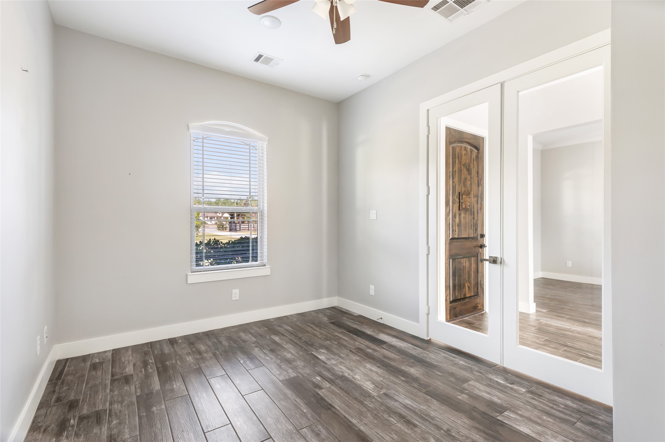 9006 Water Buck Lane Conroe, TX 77303 - Photo 25 of 48 an empty room with wooden floor cabinet and windows