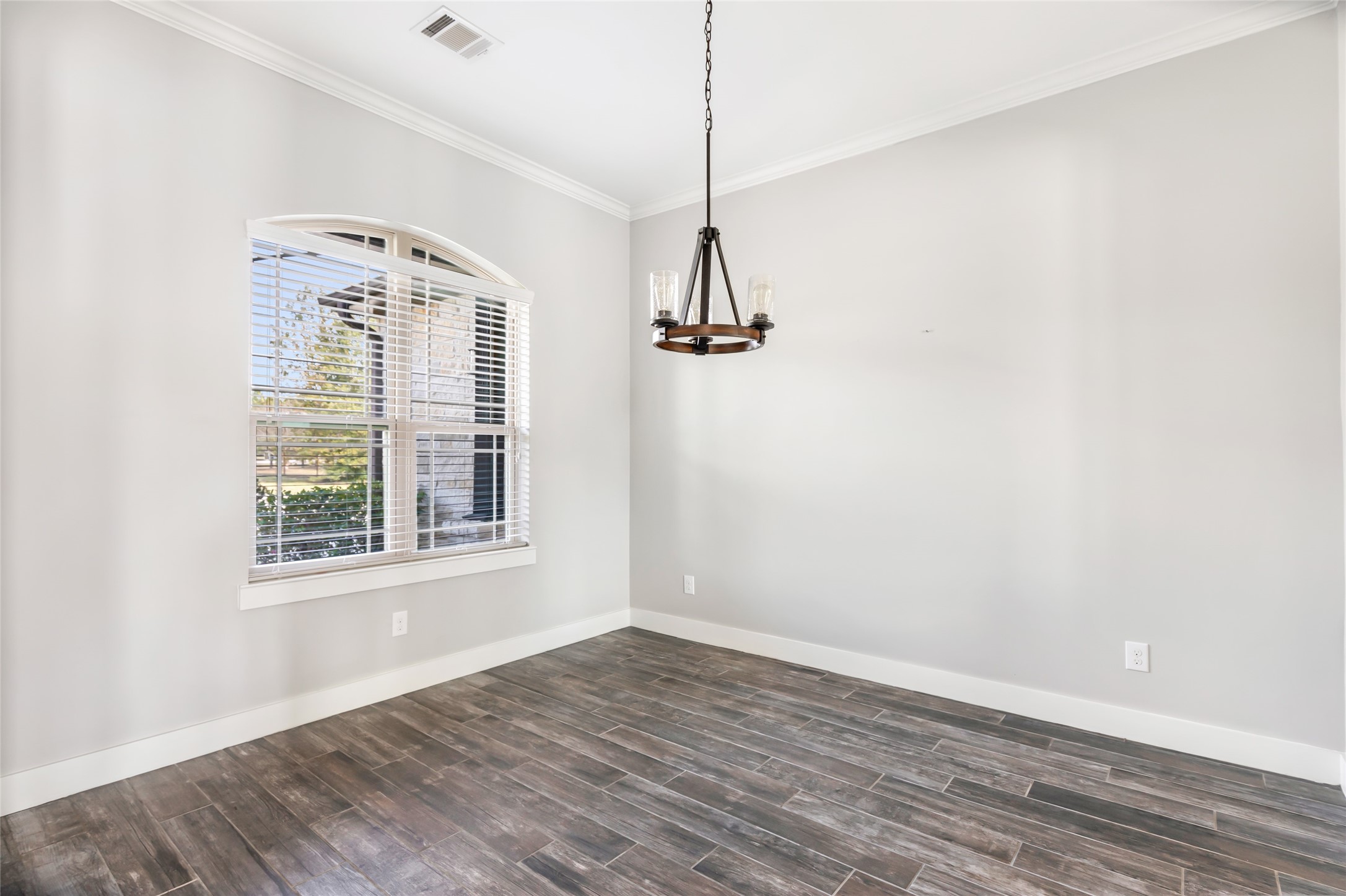 9006 Water Buck Lane Conroe, TX 77303 - Photo 26 of 48 an empty room with wooden floor a ceiling fan and windows