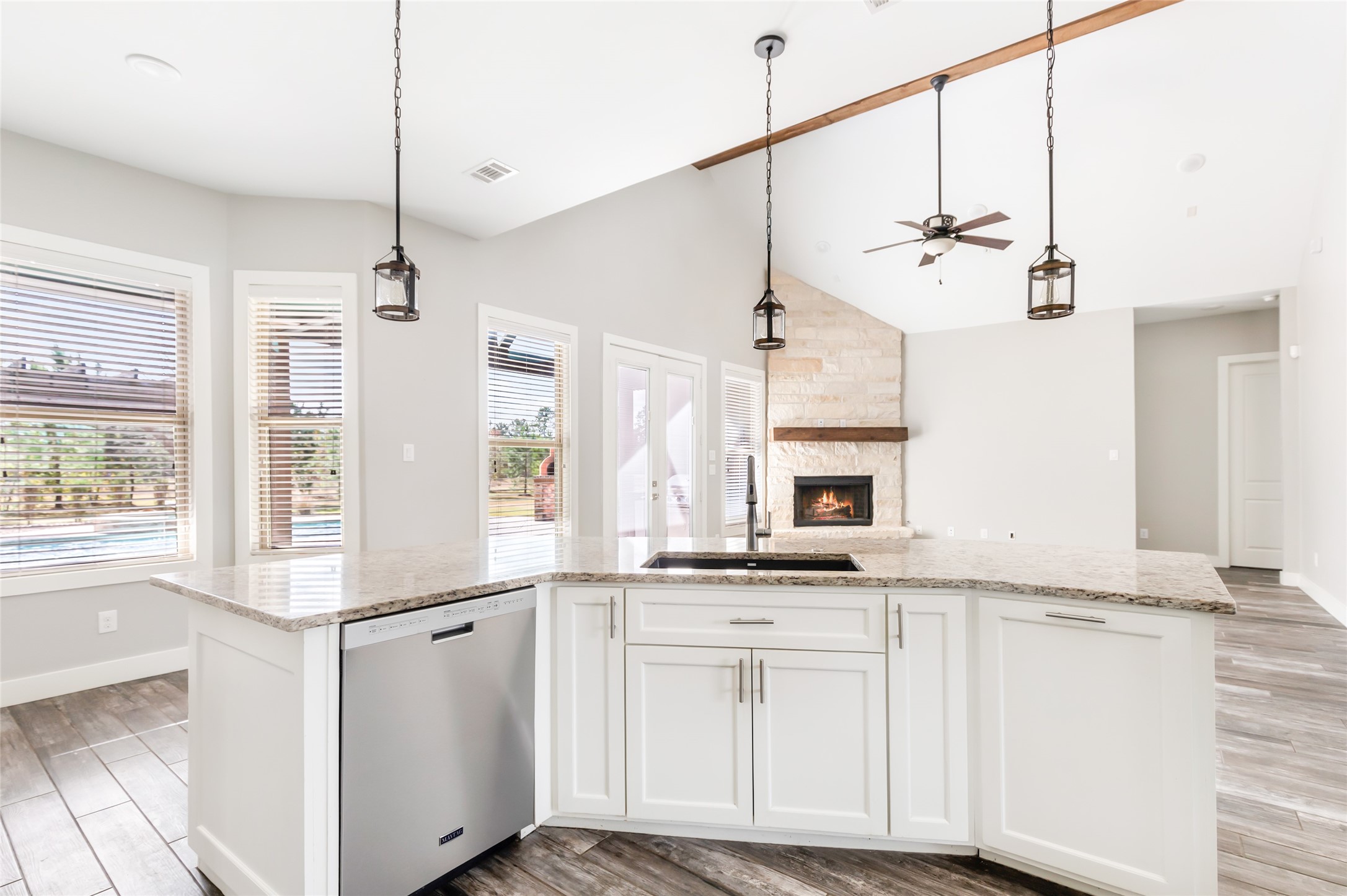 9006 Water Buck Lane Conroe, TX 77303 - Photo 33 of 48 a kitchen with kitchen island granite countertop a sink a counter space appliances and cabinets