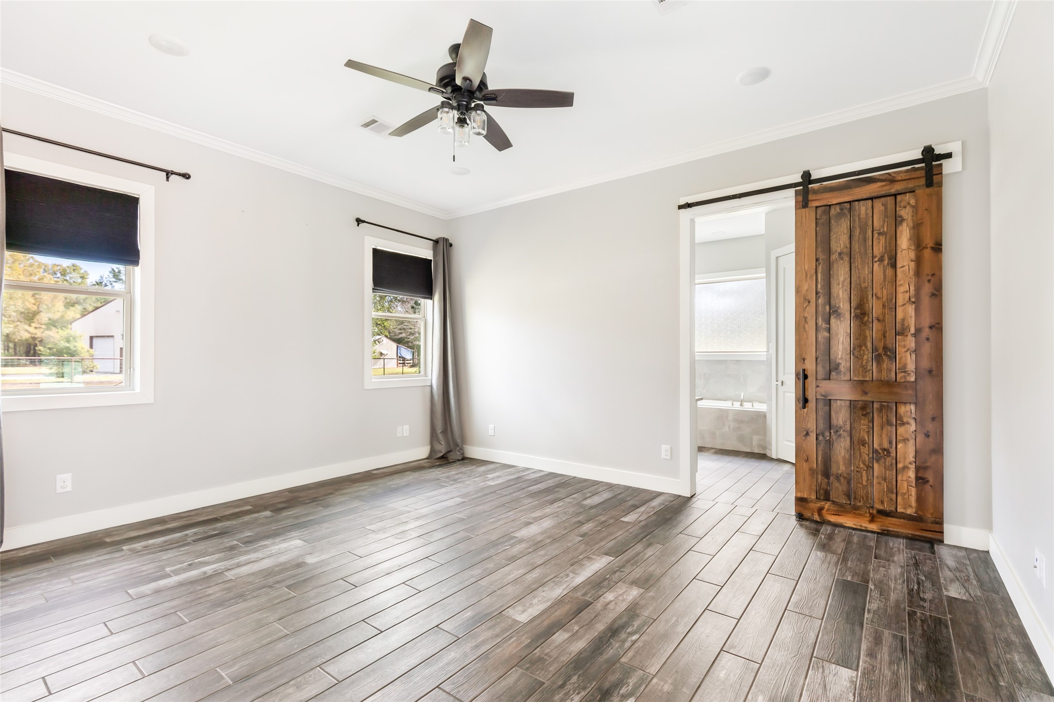 9006 Water Buck Lane Conroe, TX 77303 - Photo 40 of 48 a view of an empty room with wooden floor and a window
