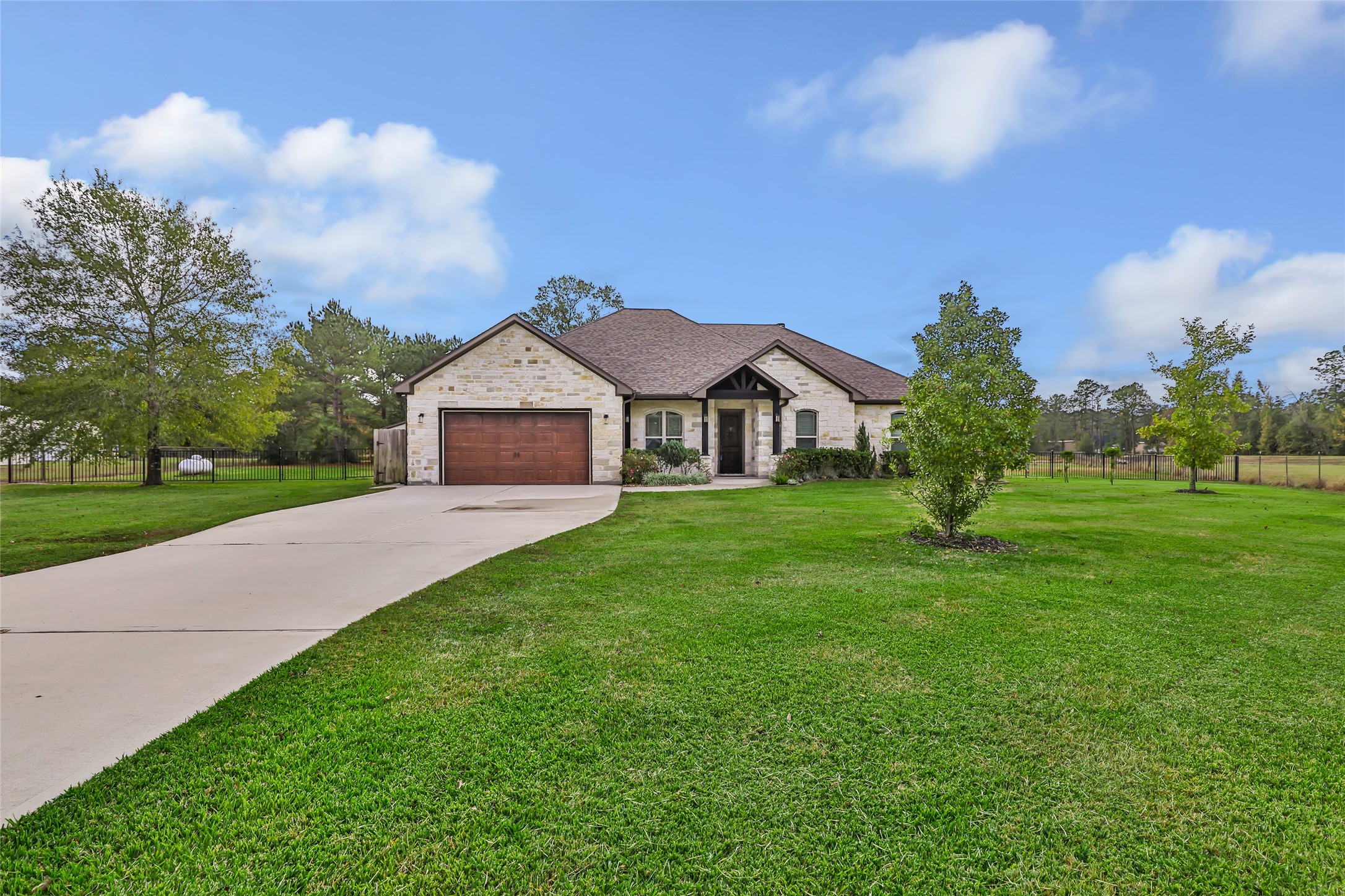9006 Water Buck Lane Conroe, TX 77303 - Photo 6 of 48 a front view of a house with garden