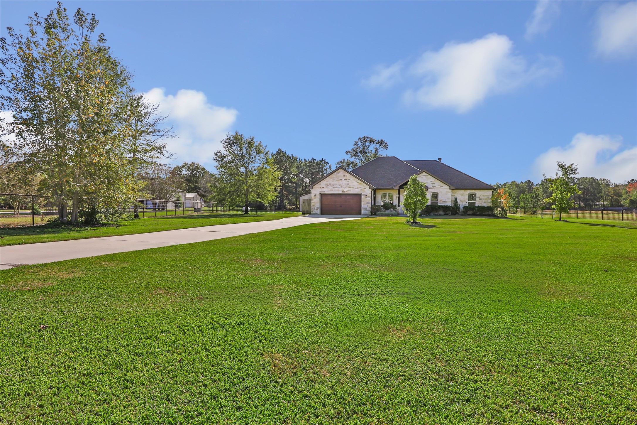 9006 Water Buck Lane Conroe, TX 77303 - Photo 7 of 48 a view of a green field with house in the background