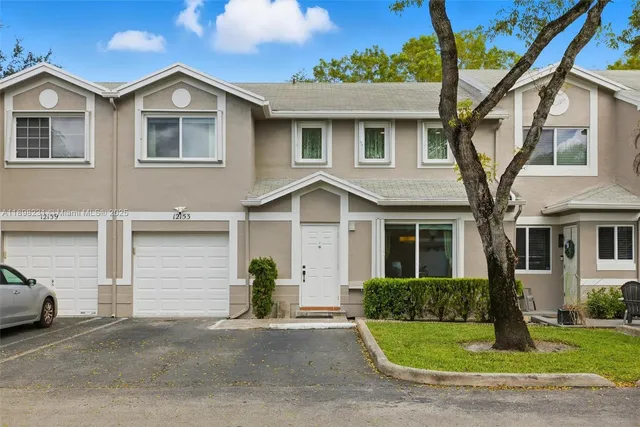a view of staircase with white walls and wooden floor